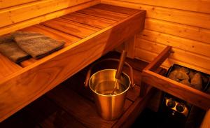 a inside of a sauna with a bucket in it at Jättiläisenmaa in Paltamo +43 photos