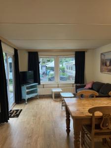 a living room with a couch and a table at KD 743 - Vakantiepark Kijkduin in The Hague