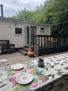 a table with plates and glasses on a patio at KD 743 - Vakantiepark Kijkduin in The Hague