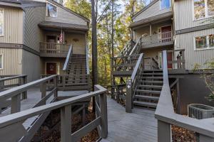 a stairway leading up to a house with stairs at Buckanoe Condo -Hiking Trails Wood-Burning Fireplace Community Pools in Holcomb