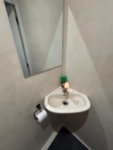 a bathroom with a white sink and a mirror at La Cachette du Sud in Vallauris