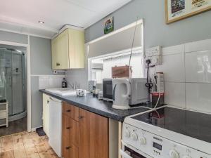 a kitchen with a sink and a counter top at Bluebird Chalet - Uk38524 in Mundesley