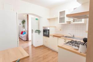 a kitchen with white cabinets and a stove top oven at Apartments Sanja in Makarska