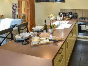 a kitchen with a table with bread and cheese on it at The Byre in Helmsley +3 photos