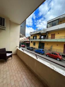 a balcony with cars parked on a city street at Luc's Home in Frattaminore