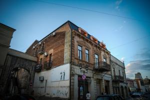 an old brick building on a city street at Hotel BABU in Kutaisi