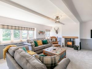 a living room with couches and a fireplace at Clearview - Cottage in Barlow