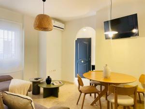 a living room with a table and a blue door at Comeback Sweet Summer Day in Torrenueva