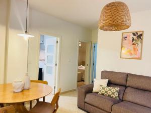 a living room with a couch and a table at Comeback Sweet Summer Day in Torrenueva