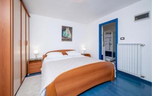 a bedroom with a large bed in a room at Nice Apartment In Rabac With Wifi in Rabac
