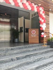 a entrance to a building with red and white balloons at Aanvi Suites RR nagar in Bangalore