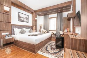 a hotel room with a bed and a desk at The Stay Villa in Srinagar
