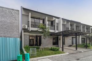 an apartment building with a lot of windows at Arumnala with butler and Breakfast at KBP in Gantungan