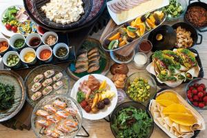 a table topped with lots of different types of food at The Royal Park Hotel Iconic Tokyo Shiodome in Tokyo