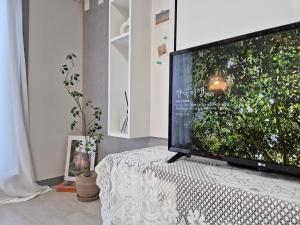 a large television sitting on a table in a room at Eumm stay in Cheongju