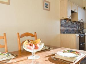 a wooden table with a bowl of fruit on it at Seasider in Whitby