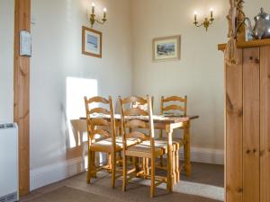 a dining room with a table and four chairs at Seasider in Whitby