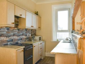 a kitchen with a sink and a stove top oven at Seasider in Whitby