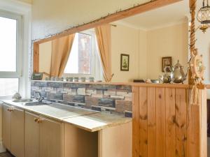 a kitchen with a counter and a sink and a window at Seasider in Whitby