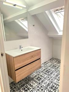 a bathroom with a sink and a mirror at Apartamentos Mar de Nanín in Sanxenxo +55 photos