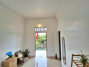 a living room with a door leading to a patio at Immersive Homestay Ninh Binh in Văn Ha