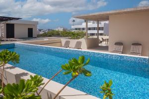 a swimming pool on the roof of a house at MK Playa del Carmen in Playa del Carmen