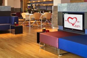 a lobby with a tv with a heart on the screen at IntercityHotel Bonn in Bonn