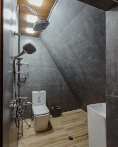a bathroom with a shower and a toilet in it at A-Frame by East West in Gabala, Azerbaijan in Gabala +14 photos
