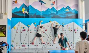 a group of people climbing a climbing wall at Lub d Phuket Patong - Near Patong Beach & Vibrant Social Vibe in Patong Beach +38 photos