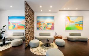 a room with chairs and tables and paintings on the wall at Art Hotel City Leipzig in Leipzig