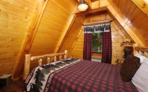 a bedroom with a bed in a log cabin at Bear Mountain Retreat in Gatlinburg