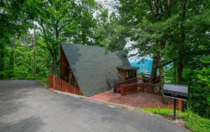 a large house with a deck and a piano at Bear Mountain Retreat in Gatlinburg