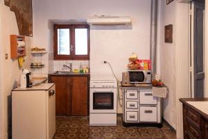 a kitchen with a white stove and a microwave at Principe in Masserano
