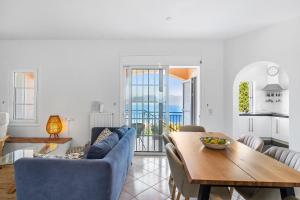 a living room with a table and a blue couch at Villa Fortuna in Nikiana