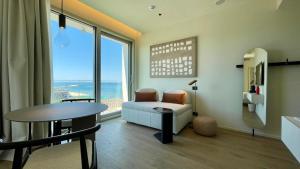 a living room with a table and a chair at Opera Suite Hotel Pesaro in Pesaro +74 photos