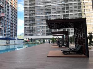 a large building with a pool in the middle of a city at Pool View Studio - 168 Park Selayang in Batu Caves +8 photos