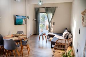 a living room with a table and a couch at Nasis Home II in Mytikas