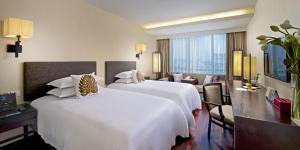 Postel nebo postele na pokoji v ubytování SSAW Boutique Hotel Hefei Intime Centre