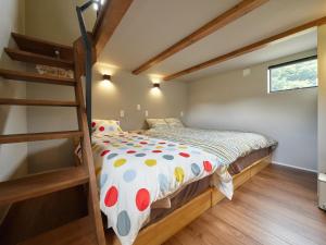 a bedroom with a bunk bed and a ladder at Hokuto Cottage BLUBLU - 北杜コテージ ブルブル - in Hokuto