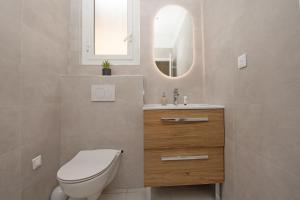 a bathroom with a toilet and a sink and a mirror at Deux pièces abba in Cap d'Ail +12 photos