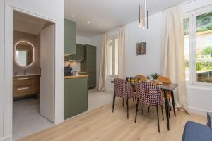 a kitchen and dining room with a table and chairs at Deux pièces abba in Cap d'Ail