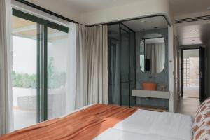 a bedroom with a bed and a mirror at Cavo Marelia in Amoopi