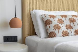 a bedroom with a bed with a pillow and a lamp at Cavo Marelia in Amoopi