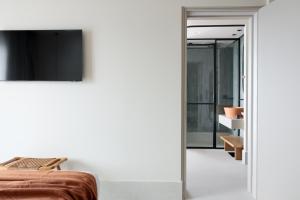 a bedroom with a bed and a television on a wall at Cavo Marelia in Amoopi