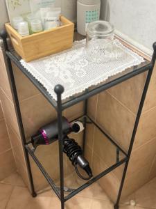 a table with a hair dryer and a glass on it at Cà del Vescovo in Imperia