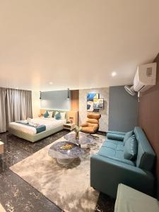 a living room with a couch and a bed at Orchard Bliss in Bhopal +93 photos