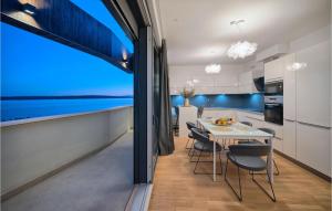 a kitchen and dining room with a table and chairs at Nice Home In Kastel Gomilica With Sauna in Kaštela
