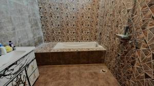 a bathroom with a tub and a sink at Navigator's Nook in Dehradun
