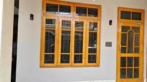 a wooden door and window on a building at Navigator's Nook in Dehradun