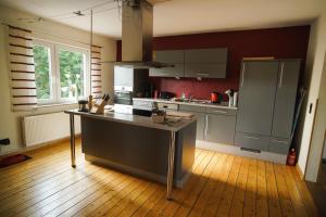 a kitchen with a island in the middle of a room at Haus "Belvidere" in Elend